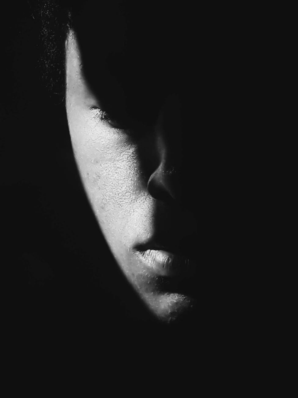 A person in darkness representing personal struggle with anxiety and depression