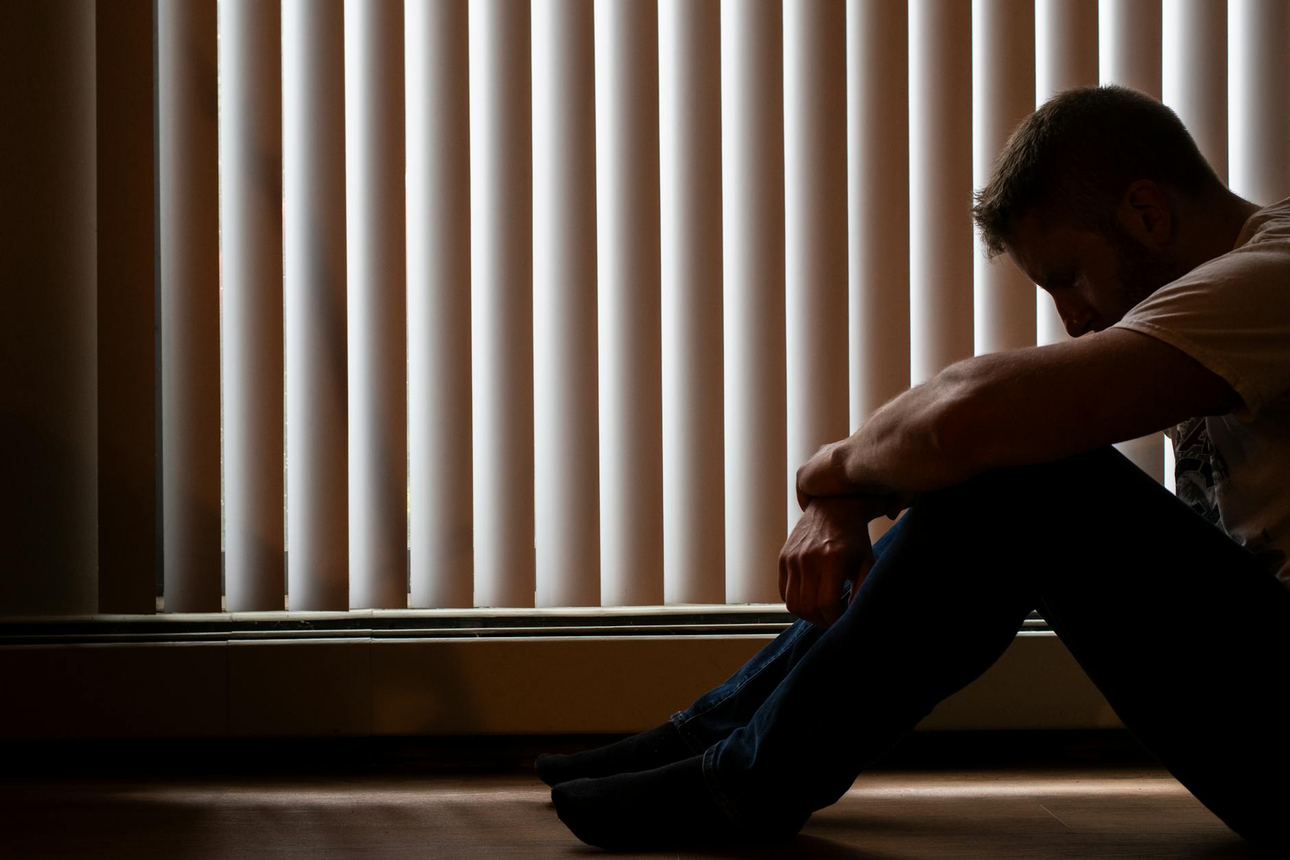 person sitting alone looking anxious and overwhelmed representing personal anxiety experience